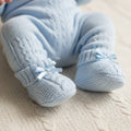 Blue baby booties worn on baby's feet